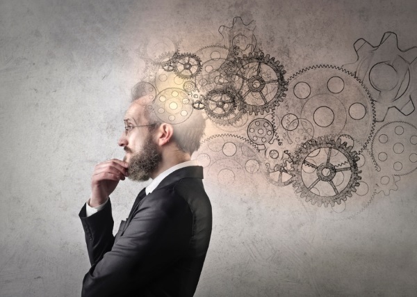 man thinking with cogs in foreground 