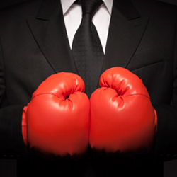 person in suit with boxing gloves on