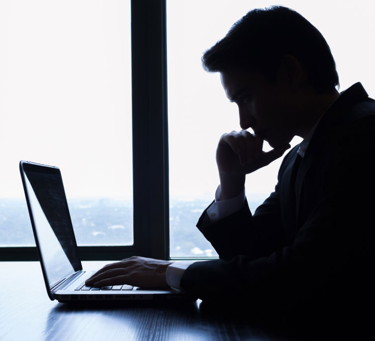 man thinking at computer 