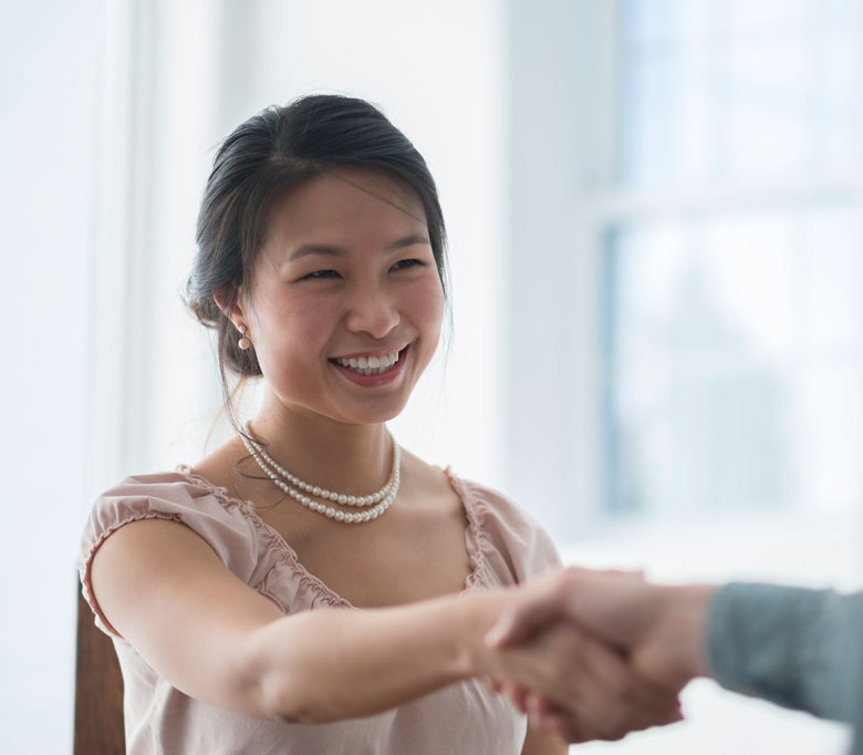 woman shaking hands with man 