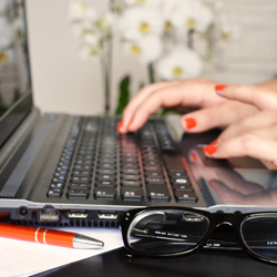 hands typing on computer