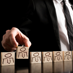 man placing blocks in a line 