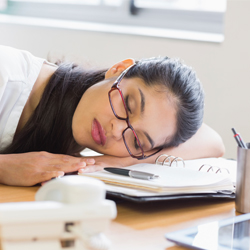 woman sleeping on her desk 