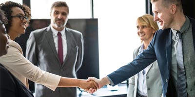 A business meeting concludes with a handshake