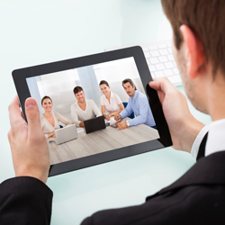 man looking at photo of employees