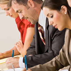 three people writing